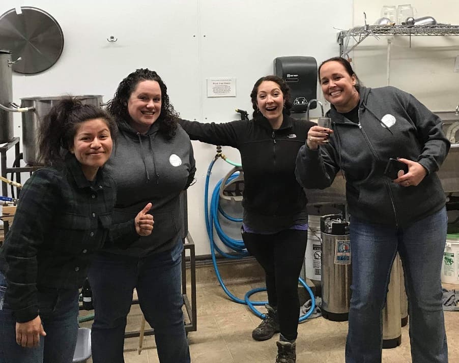 Photo: HHB members Ana Rodriguez, Caitlin Hoy, Kristina Watson, and Chrissy Gierek pause during a brew session at Humboldt Beer Works.